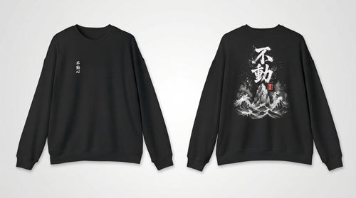 Black crewneck sweatshirt front and back side by side, small Fudoshin chest print and Sumi-e wave-and-mountain back design, MINDO Studio
