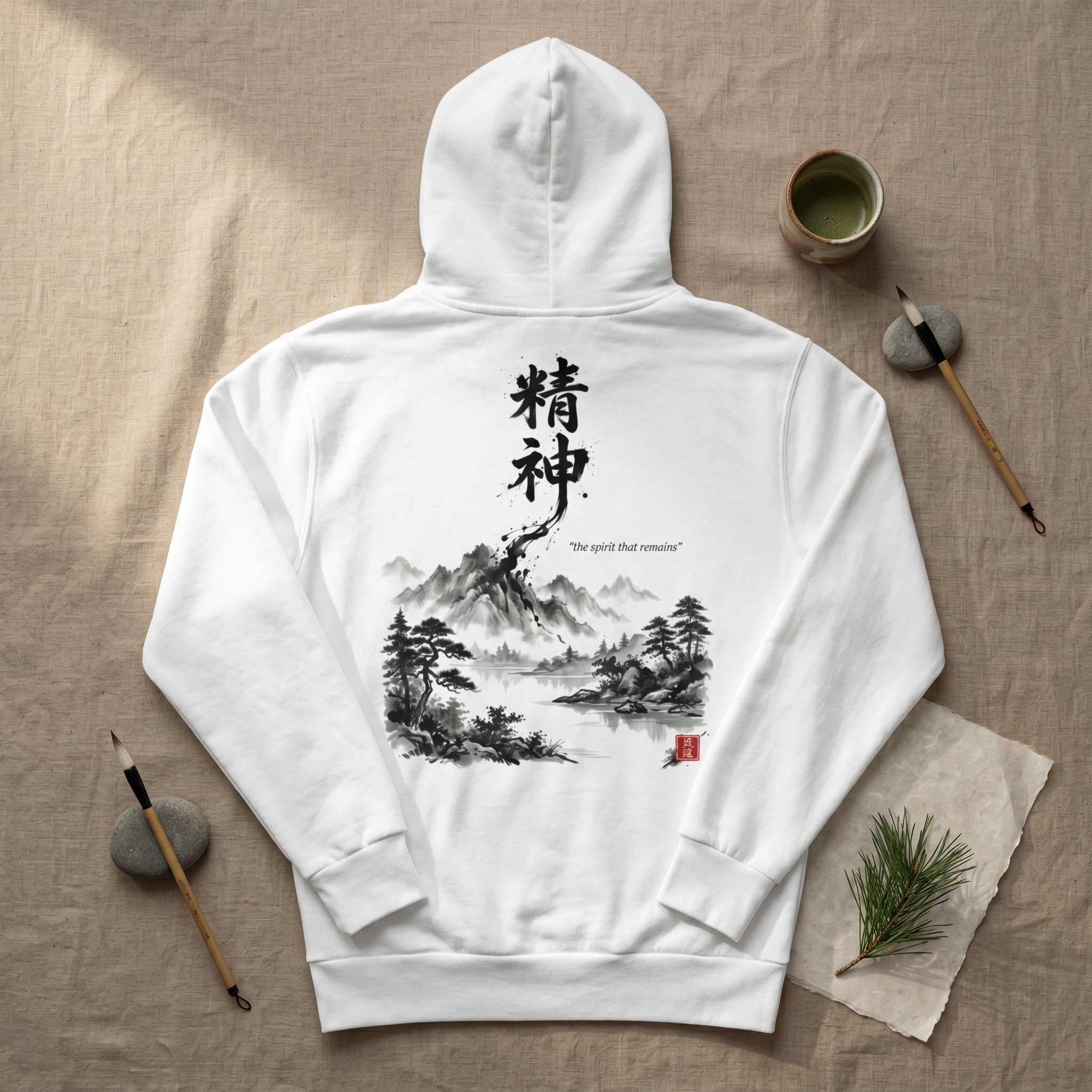 White unisex hoodie with hand-brushed Japanese calligraphy 精神 
and Sumi-e mountain landscape on the back, red Hanko seal signature, 
MINDŌ Studio Seishin collection